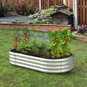 Dwellcozy Metal raised garden bed with plants and flowers in the backyard.