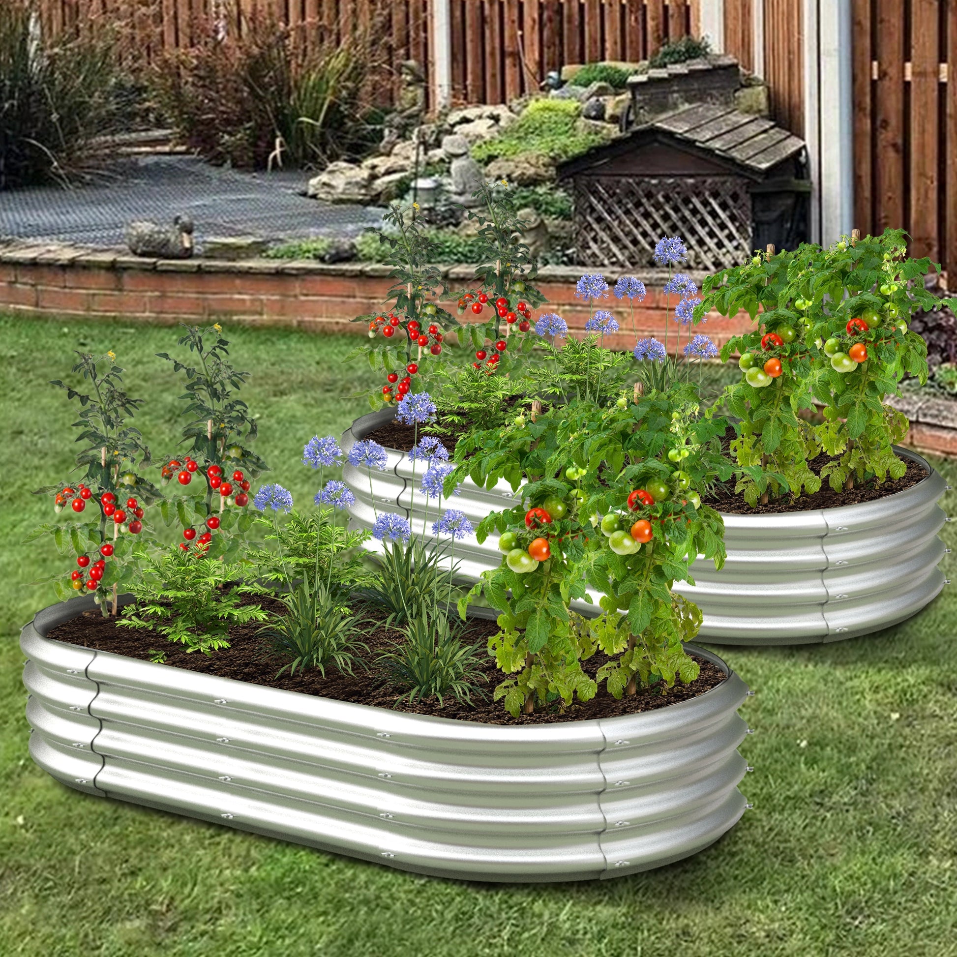 Dwellcozy 2 metal raised garden beds with plants and flowers in a backyard.