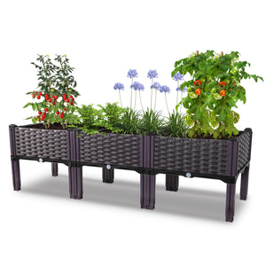 Dwellcozy plastic raised garden bed with plants on a white background.