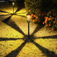 Dwellcozy outdoor solar pathway light illuminated by 2 solar-powered outdoor lights with flowers on the side.